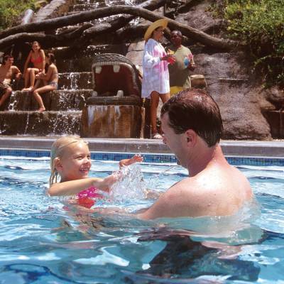 a group of people swimming in a pool of water