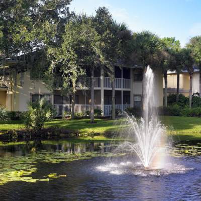 a fountain in front of a lake