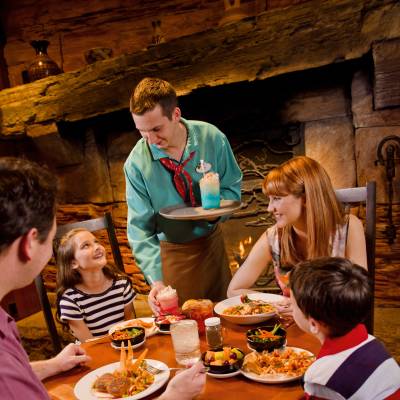 a group of people sitting at a table eating food