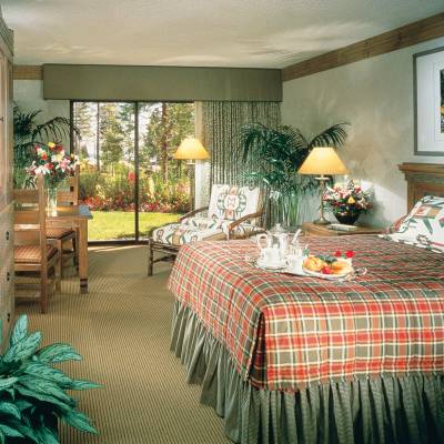 a living room filled with furniture and a bed