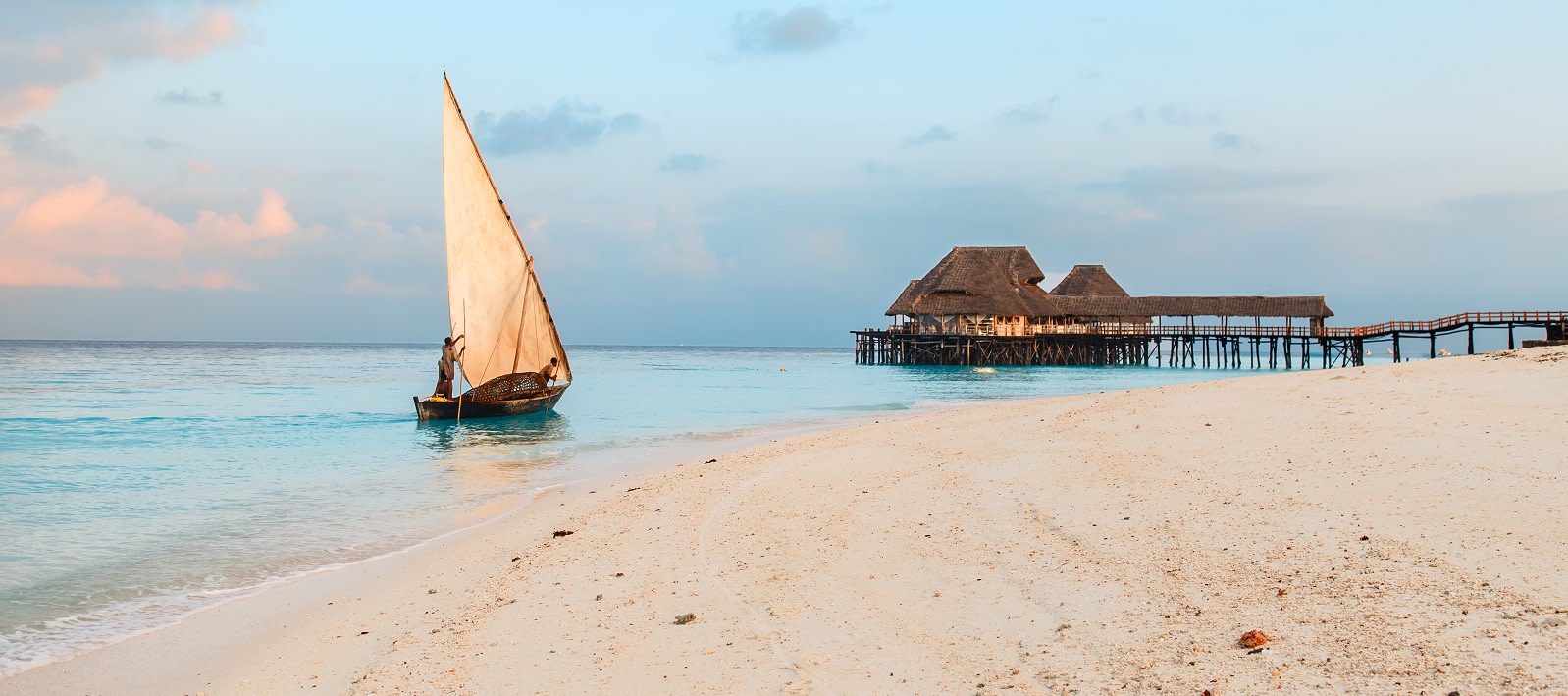Beautiful sunrise over ocean with fishing boat, fishermen, hut, Nungwi, Kendwa, Zanzibar island, Tanzania Africa zanzibar