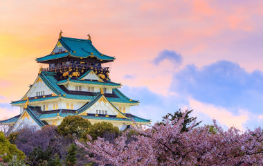 Enchanting Travels Japan Tours Twilight at Osaka castle during Cherry blossoms season in Osaka, Japan - History of Japan
