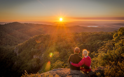 A-young-couple-enjoying-the-beautiful-sunrise-on-Mount-Kaputar-in-New-South-Wales-Australia