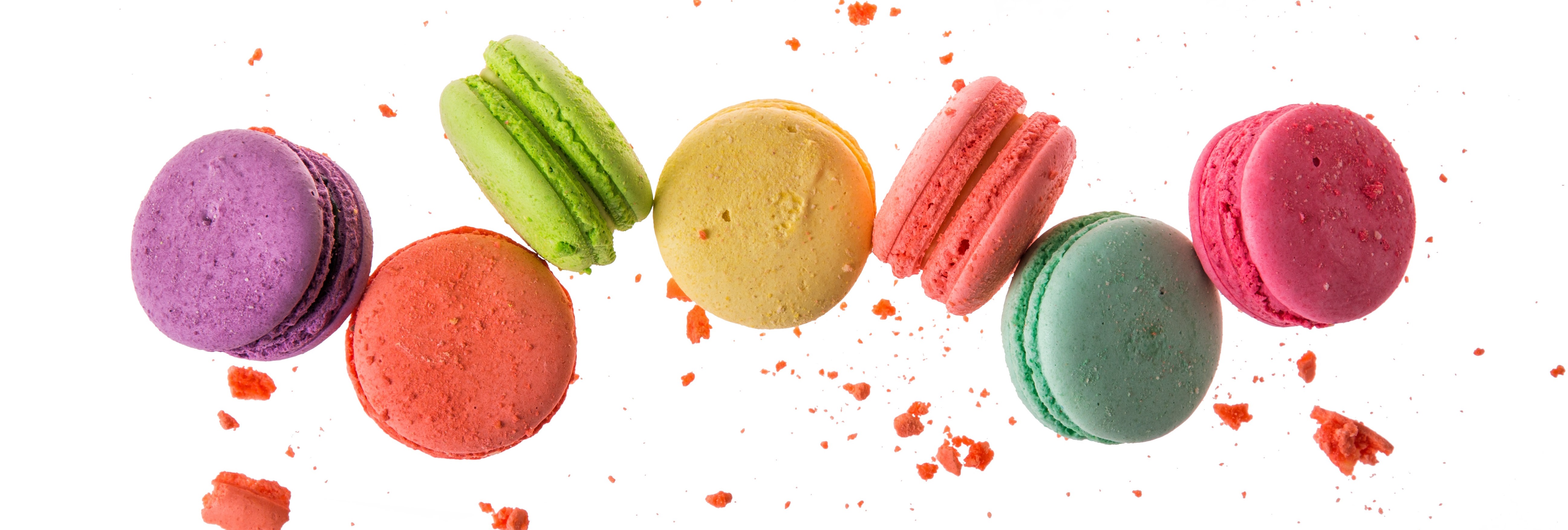 Enchanting Travels France Tours French macaroons isolated on white background. Cookies falls mixed with crumbs Enchanting Travels France Tours French macaroons isolated on white background. Cookies falls mixed with crumbs