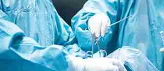 Two surgeons in blue scrubs and white gloves are performing a surgical procedure. They are holding surgical instruments, and one is assisting the other by holding and navigating tools carefully over the patient, who is not visible.