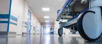 A hospital bed in a hallway.