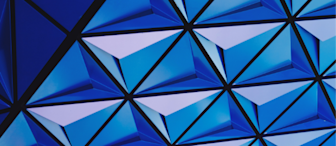The image shows a complex geometric pattern of interconnected, blue triangular facets. The design creates a futuristic and symmetrical 3D effect, with varying shades of blue contributing to an overall sense of depth and movement.