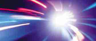 An abstract image depicting vibrant light streaks radiating outward from a bright center, creating a dynamic sense of motion. The colors predominantly feature shades of blue, pink, and purple against a dark background, enhancing the overall glowing effect.