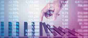 A hand is seen stopping a row of falling dominoes against a backdrop of fluctuating stock market numbers. The image symbolizes intervention and stability amidst financial fluctuations.