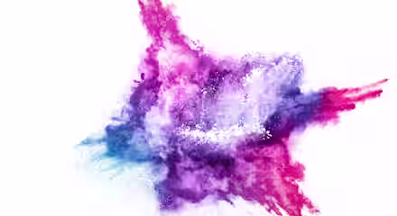 A vibrant explosion of colorful powder on a white background, resembling an abstract star shape. The colors include shades of pink, purple, blue, and a hint of red, blending seamlessly with each other and creating a dynamic, energetic visual effect.