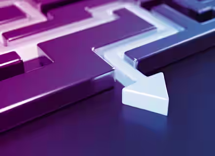 A close-up image of a metallic maze with smooth, polished surfaces. The maze is displayed in shades of purple and blue. A white arrow is seen pointing through the maze, indicating a path.