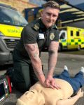 A paramedic performing CPR on a mannequin