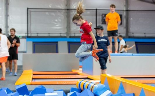 girl jumping into a foam pit