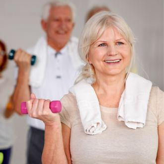 A senior lifting a small weight in a senior fitness class at Hatfield Swim Centre