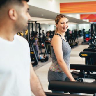 An image of a couple training together in a gym