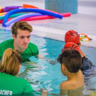 A teacher showing new techniques to Swim School students