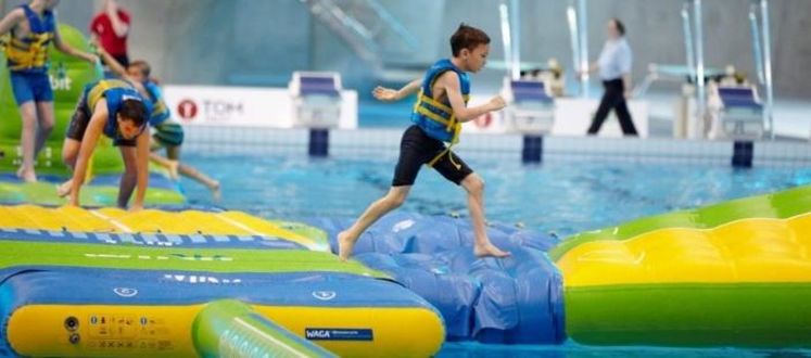 Child running across pool inflatable at Southbury Leisure Centre