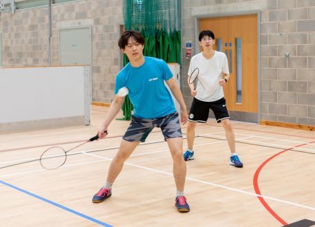 two young males playing badminton