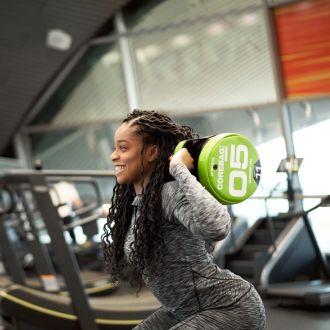 A photo of a woman lifting a weight