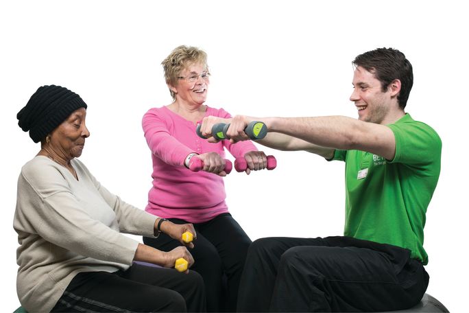 Adult_male_and_female_on_fitball_with_dumbbells.jpg