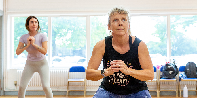 Close up on a Zumba instructor leading a class.
