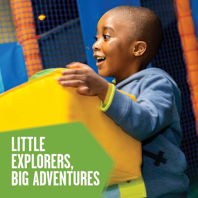 A young child playing with soft play.