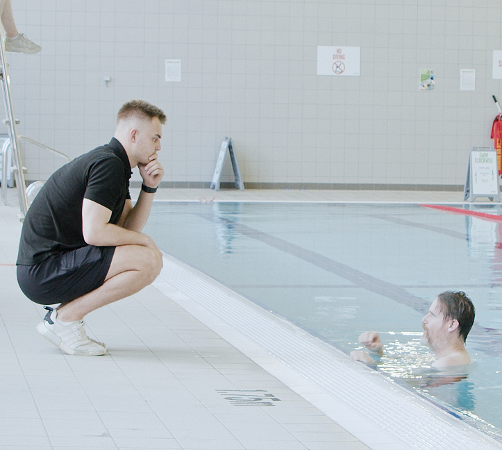 Man in pool and instructor