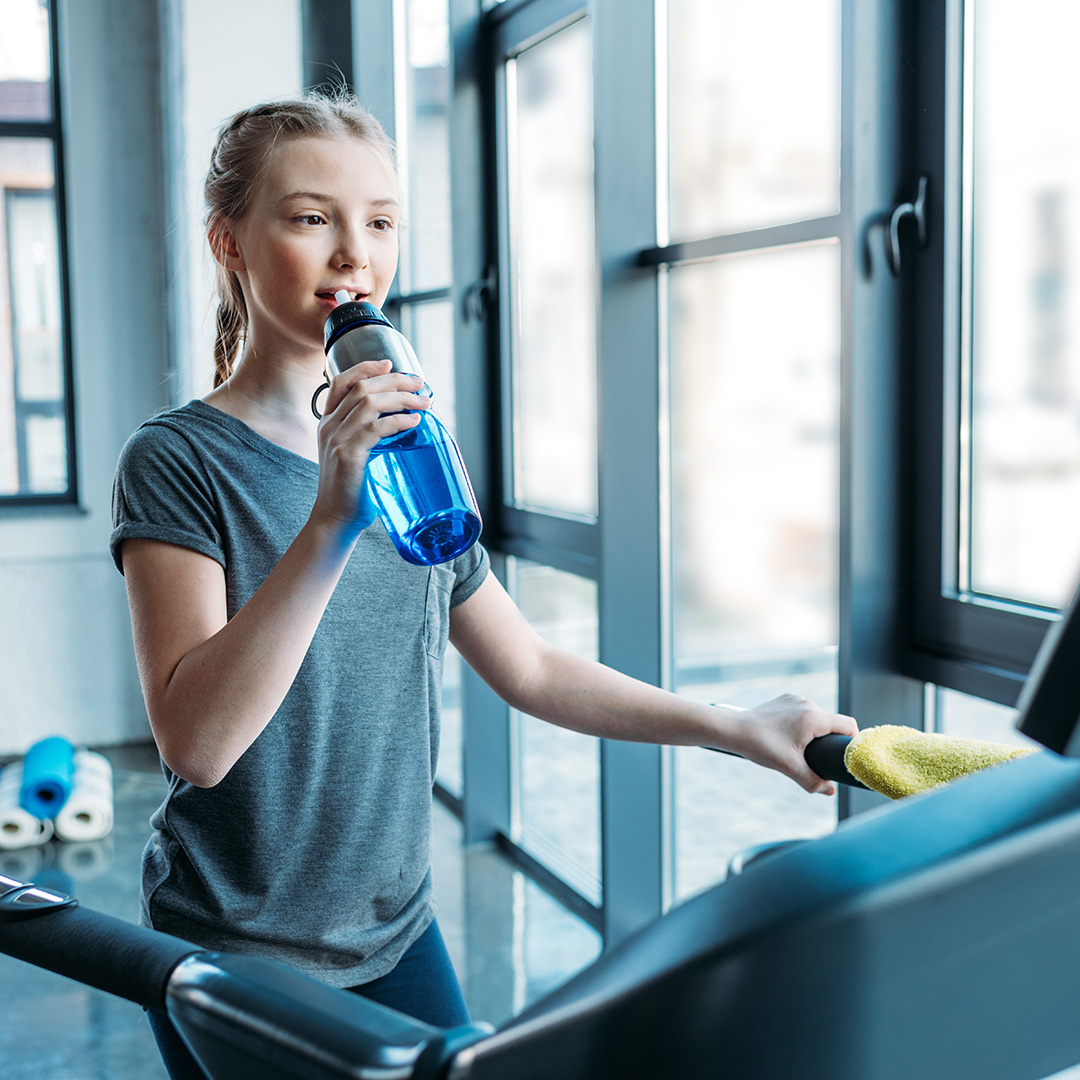 Junior female enjoying workout on treadmill