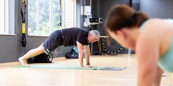 A man stretching on an exercise mat