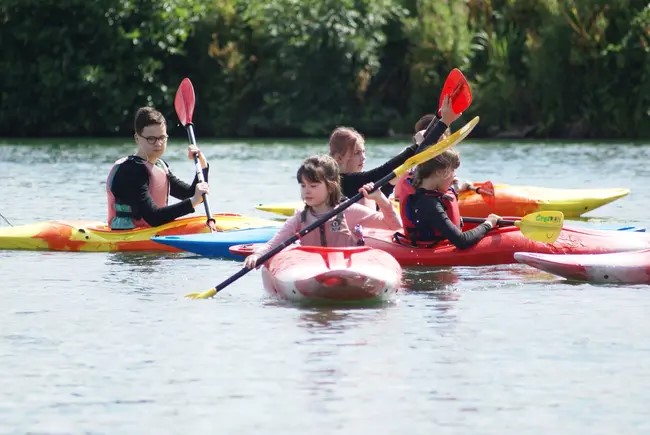 A group of young people in kayaks