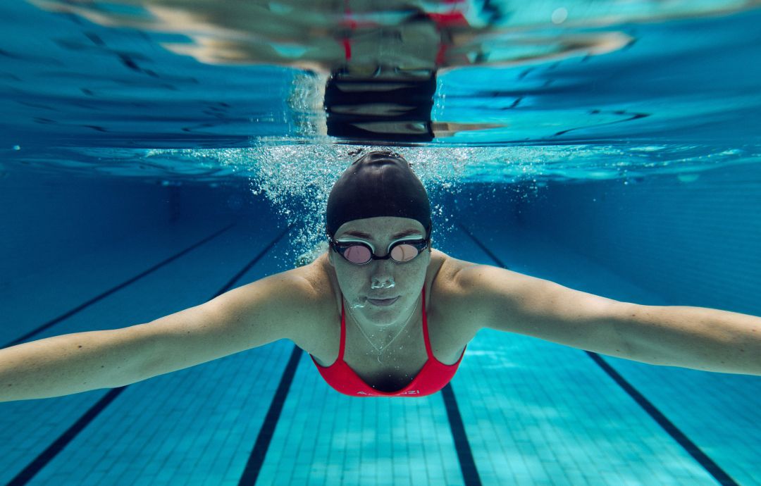 image shows a lady swimming underwater