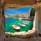 Rows of Boats Viewed Through a Stone Wall
