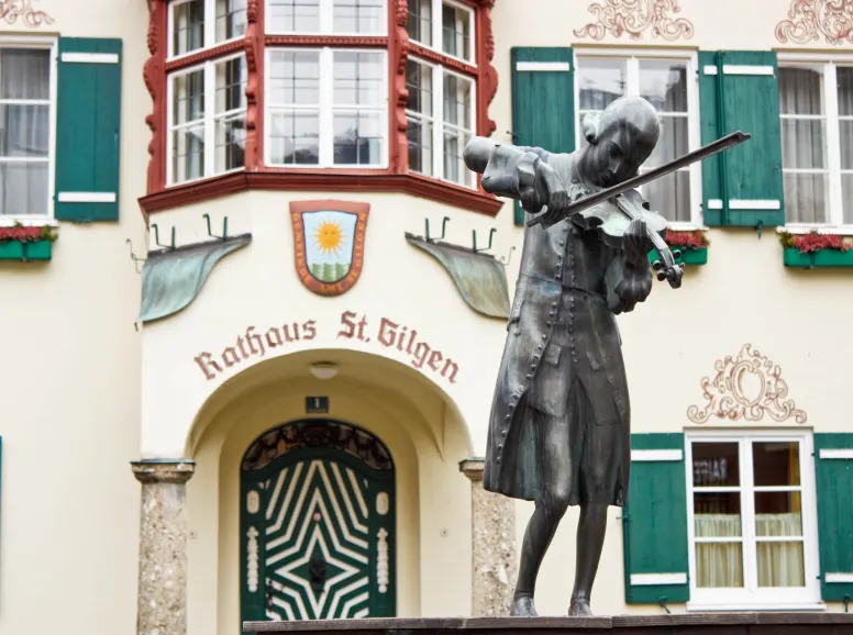 Sculpture of Mozart with Violin in Front of Historic Salzburg Building