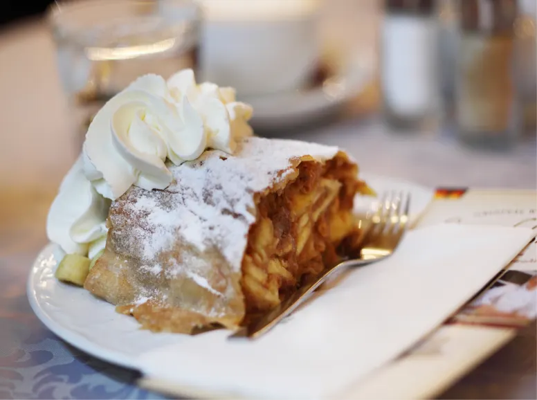 Closeup of Apple Strudel with Whipped Cream and Fork