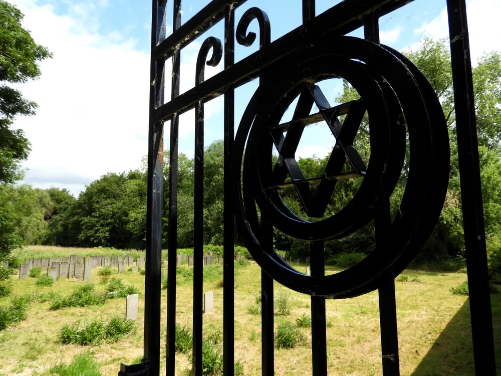 An Iron Gate with a Jewish Star Opening Towards a Jewish Cemetary