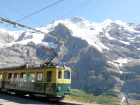 Green Tram with Mountain Backdrop Unterseen