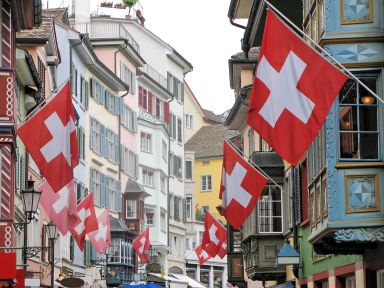 Street in Zurich Lined with Historic Buildings and Swiss Flags