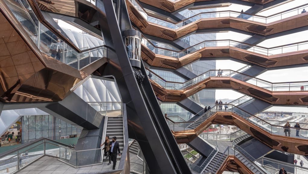 Interior view of people walking down stairs within the Vessel