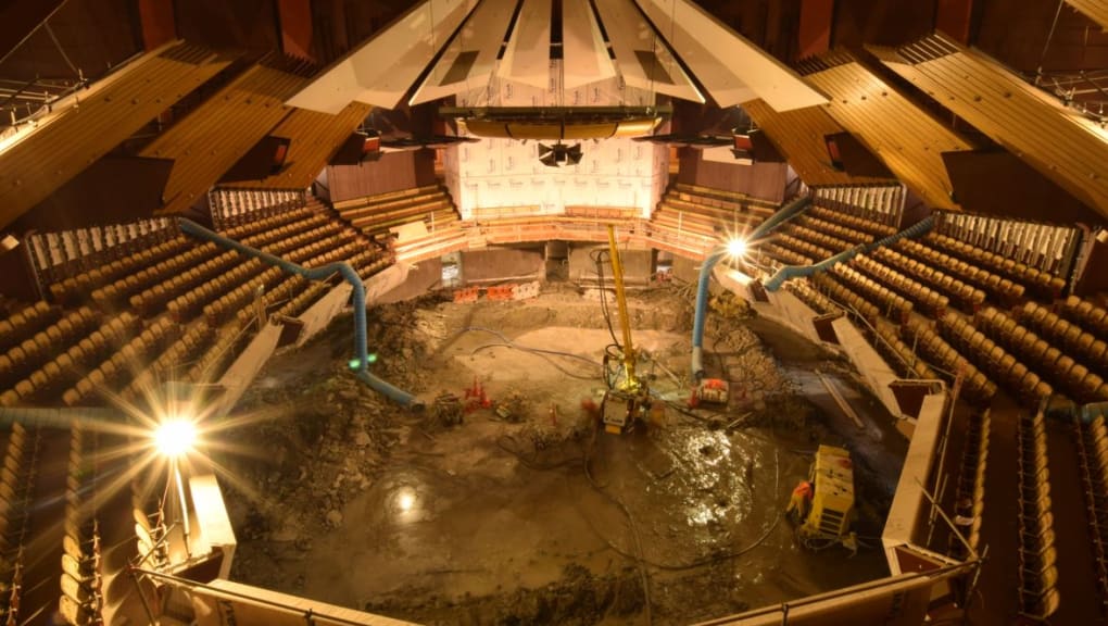 Interior night view of the construction of the Christchurch Town Hall forum