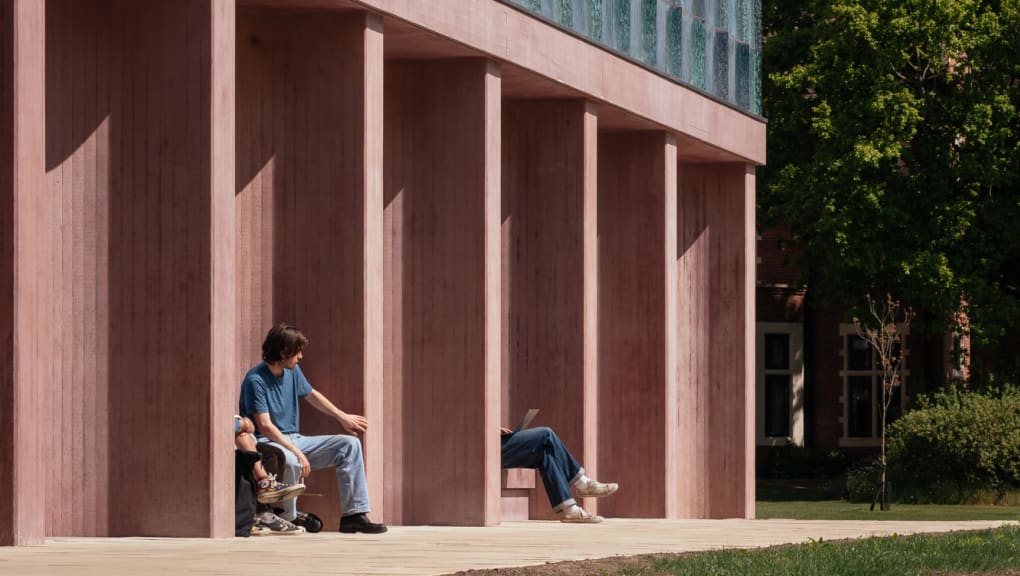 Exterior ground level view of people sitting outside Homerton Dining Hall