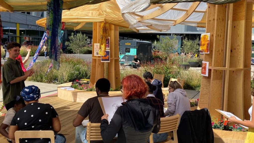 Exterior view of people working outside the People's Pavilion