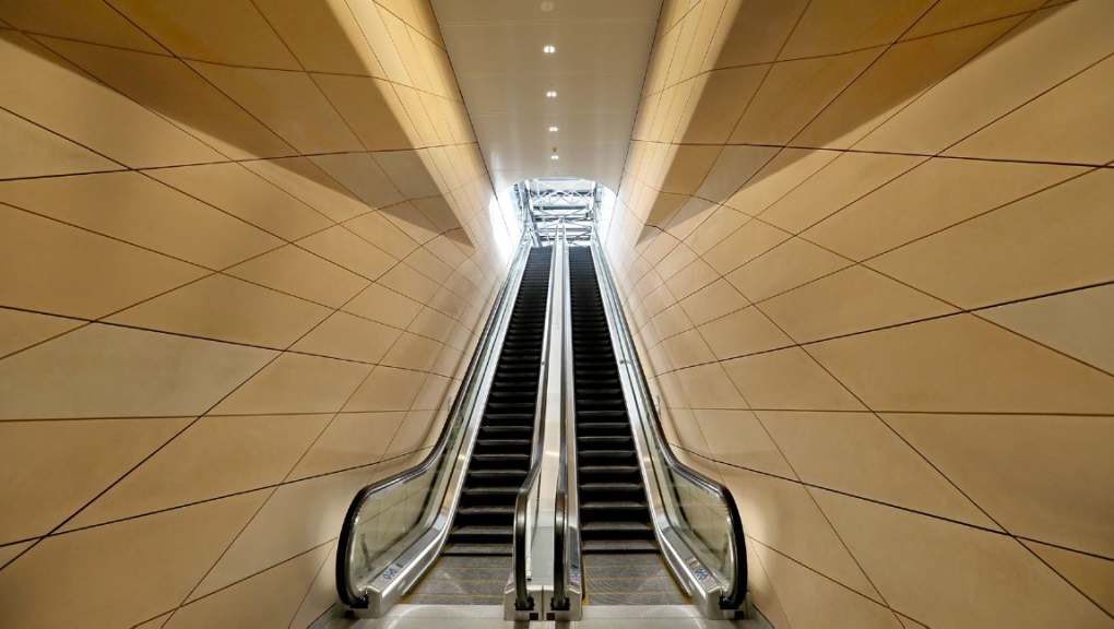 Bottom-up image of the escalators between platforms. Copyright: Aurecon GHD Joint Venture (AGJV), 2025.