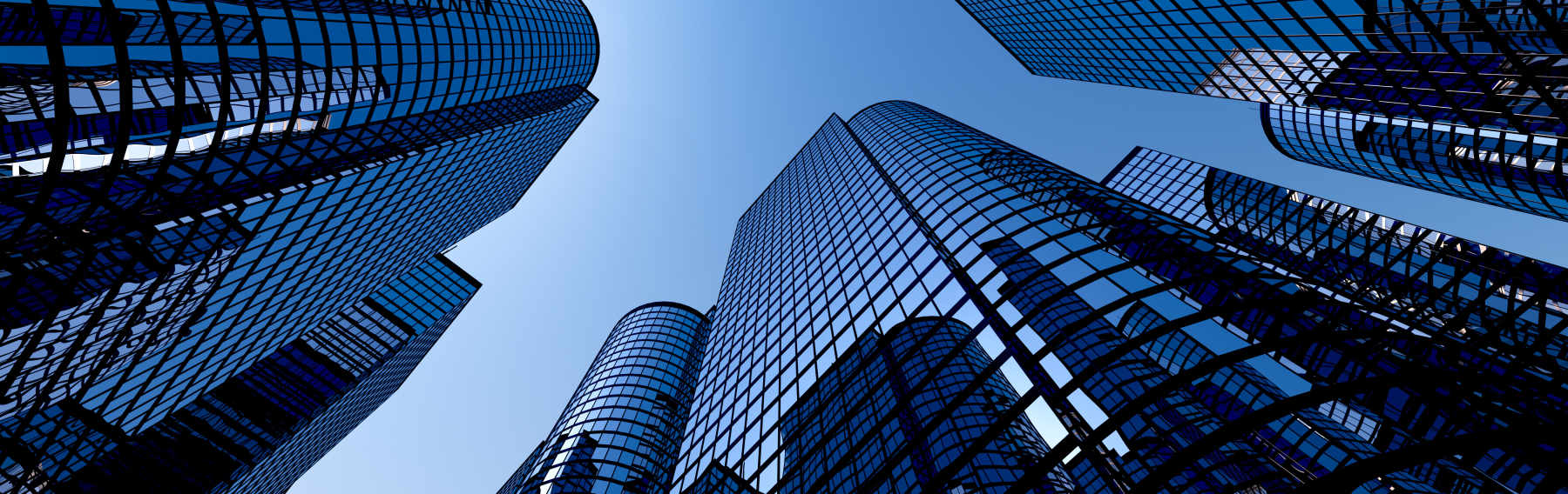 Looking up at multiple modern skyscrapers with blue glass facades against a clear blue sky.