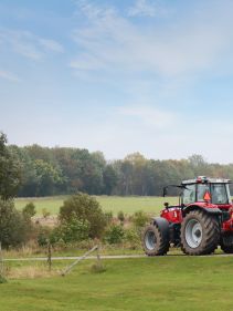 Packers - Kverneland Packomat compact and transported above ground level, dragged by tractor in a folded shape