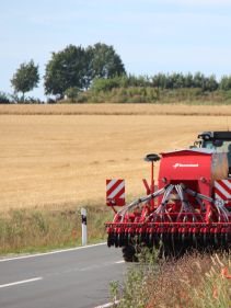 Kverneland U-drill, transported on road by tractor