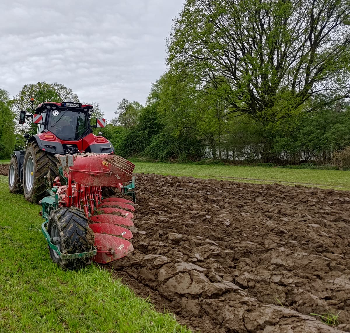 Side view of Kverneland 3400 B Variomat plough turning soil in agricultural field