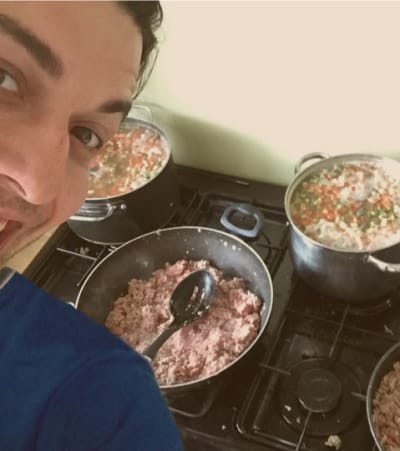 Dave preparing food for Rudie the Staffie in the family kitchen.