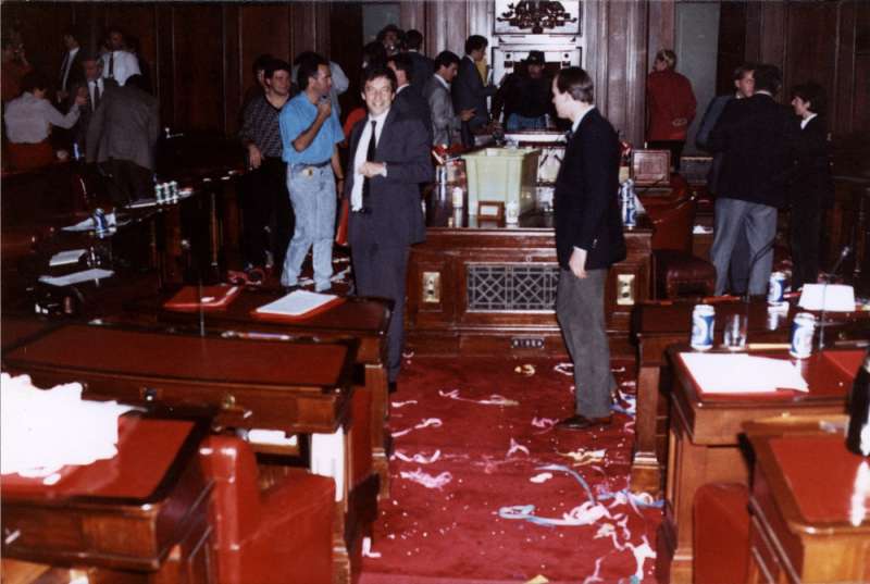 Senator Robert Hill (facing camera) and colleagues party in the Senate chamber after the last sitting. Photographer – Trevor Fowler, Hansard Reporter, MoAD Collection.