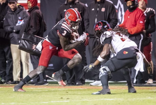 NC State Wolfpack football wideout Emeka Emezie looks for yards after the catch