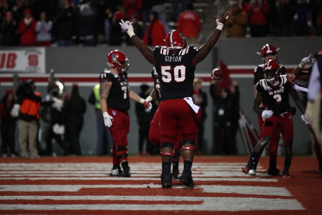 Redshirt junior center Grant Gibson celebrates in the end zone at Carter-Finley Stadium.